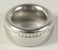 A HEAVY TITANIUM AND DIAMOND RING.