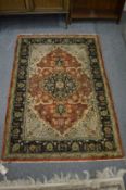 A PERSIAN PART SILK RUG with stylised floral decoration 135cm x 81cm.