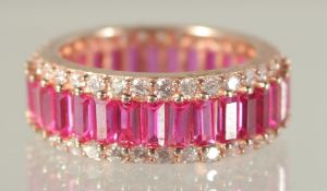 A RED STONE ETERNITY RING.