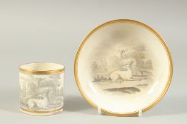A CUP AND SAUCER with scenes of two greyhounds in sepia.