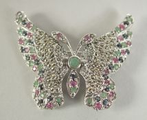 A SILVER RUBY, EMERALD AND SAPPHIRE BUTTERFLY BROOCH.
