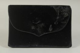 A CATHERINE WALKER, LONDON, BLACK VELVET EVENING BAG, the inside with a mirror. 7.5ins long.