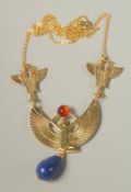 AN EGYPTIAN DESIGN PENDANT AND CHAIN.