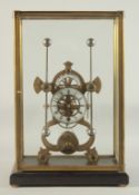 A GRASSHOPPER BRASS AND WHITE ENAMEL SKELETON CLOCK. 14ins high in a glass cover.