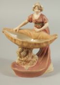 A ROYAL DUX PORCELAIN FIGURE OF A YOUNG LADY holding a sheaf No. 2099. 7ins high.