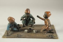 A COLD CAST BRONZE THREE BOYS PLAYING DICE 10ins long