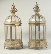 A PAIR OF COPPER CIRCULAR LANTERNS with glass sided and carrying handle. 24ins high.