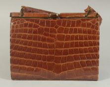 A 1960's - 1970's CROCODILE SKIN HANDBAG, 8ins long.