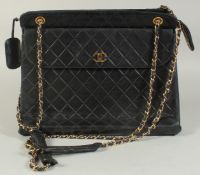 A LARGE CHANEL BLACK PADDED LEATHER BAG, 13ins long, 10ins high, with entwined gilt metal and