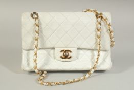 A CHANEL WHITE PADDED LEATHER EVENING BAG, 8.5ins long, with a gilt and white leather entwined strap