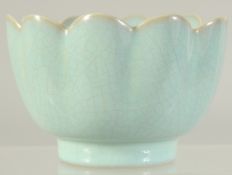 A CHINESE CELADON GLAZE PETAL FORM BOWL. 10.5cm diameter.