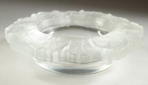 A LALIQUE CIRCULAR BOWL the rim with flower petals. 6ins diameter.