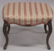 A VICTORIAN ROSEWOOD STOOL with padded top on curving legs. 1ft 11ins long.