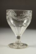 AN 18TH CENTURY IRISH GLASS RUMMER engraved with ribbon motif and garland. 5ins high.