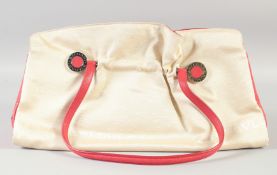 A BULGARI PART LEATHER CREAM AND RED HANDBAG with crocodile flaps. 41cm long x 22cm high.