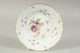 A MEISSEN PLATE white ground painted with flowers and insects. Cross sword mark in blue. 7.5ins