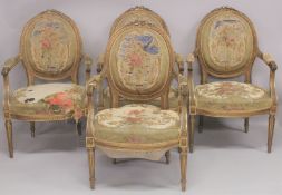 A GOOD SET OF FOUR LOUIS XVI 19TH CENTURY GILT ARMCHAIRS with oval backs and open arms, padded