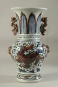 A CHINESE PORCELAIN BLUE AND RED VASE decorated with dragons. 14ins high.