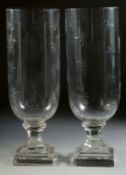 A GOOD PAIR OF SMALL CUT GLASS HURRICANE LAMPS on square bases. 13ins high.