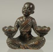 A JAPANESE BRONZE SEATED BOY. 2.5ins high.