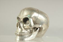 A SILVER PLATED SKULL with moving jaw. 4ins.