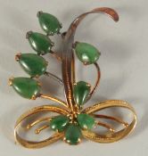 A 14CT GOLD AND JADE SPRAY BROOCH.