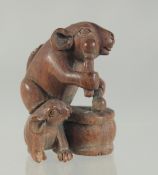 A CARVED WOOD RATS AND DRUM NETSUKE. 4.5cms.