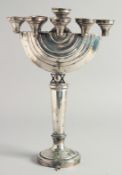 A GOOD JEWISH SILVER MENORAH on a circular base. 12ins high.