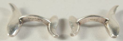A PAIR OF TIFFANY SILVER DOLPHIN AND CUFF LINKS in a Tiffany purse.