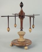 A WOODEN AND ALABASTER WOOL WINDER. 13ins high.