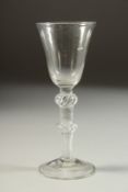 AN 18TH CENTURY ENGLISH WINE GLASS with inverted bell bowl and air twist stem, with a knop. 6ins