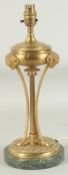 A GOOD 19TH CENTURY BRASS LAMP with ram’s mask and circular marble base. 1ft 3ins high.