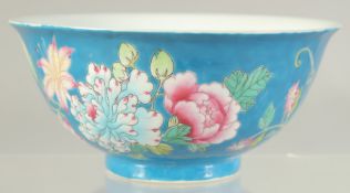 A CHINESE FAMILLE ROSE BLUE GROUND PORCELAIN BOWL decorated with flora. 15cm diameter.
