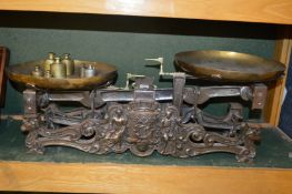 A VERY GOOD LARGE SET OF CAST IRON SCALES with brass pans and weights. 16ins long.