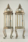 A LARGE PAIR OF COPPER CIRCULAR LANTERNS with glass sides on four curving legs. 32ins high.