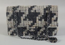 A GOOD CHANEL BLACK AND WHITE WOVEN TWEED/FABRIC BAG with black leather interior with entwined