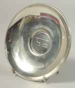 A CARTIER CIRCULAR PEWTER PRESENTATION PLATE. 4.75ins diameter, boxed