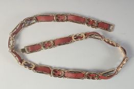 AN ESCADA GILT & LEATHER BELT. No. 51230 -972 Escada, Made in Italy. 36ins long.