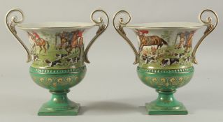 A PAIR OF SEVRES DESIGN GREEN GROUND, TWO HANDLED URN SHAPED HUNTING SCENES VASES. 11ins high.