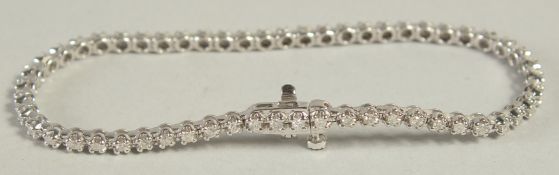 A 9CT WHITE GOLD AND DIAMOND LINE BRACELET, over 1 carat of diamonds.