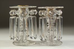 A GOOD PAIR OF REGENCY CUT GLASS LUSTRES with prism drops and circular bases. 5.5ins high.