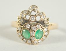 A 9CT. GOLD EMERALD AND DIAMOND SWEETHEART RING.