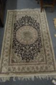 A PERSIAN PART SILK RUG, cream and blue ground with stylised floral decoration 155cm x 93cm.