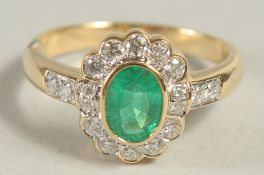 AN 18CT YELLOW GOLD, EMERALD AND DIAMOND RING.