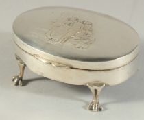 AN OVAL SILVER JEWELL BOX, the lid repousse with figures, velvet interior on claw feet.