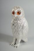 A SILVER PLATED OWL SUGAR SIFTER with glass eyes. 6ins high.