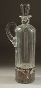 A DUTCH GLASS LIQUEUR DECANTER AND STOPPER with carrying handle and silver top and base. 11.5ins