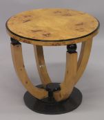 AN ART DECO STYLE BLONDWOOD CIRCULAR TABLE on curving supports. 1ft 10ins high x 2ft 11ins