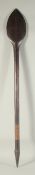 A SOUTH SEAS ISLAND WOODEN PADDLE with pointed end. 3ft 10ins long.