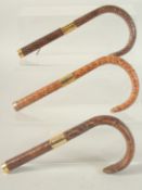 THREE SNAKESKIN STICK HANDLES.